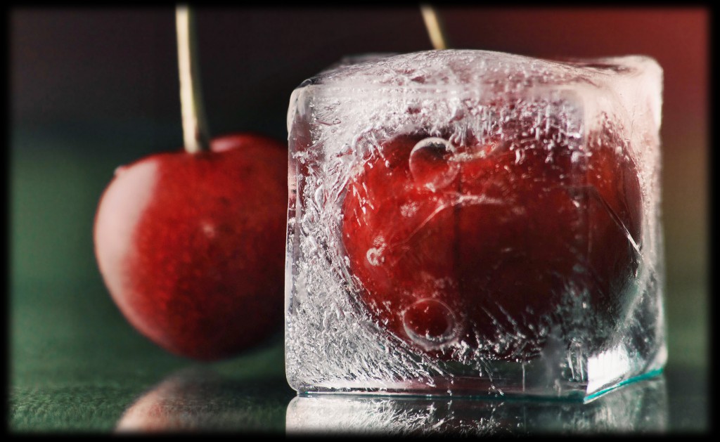 sweet frozen delicious red cherry in ice on green table macro ba